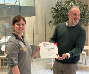 Tara receiving her award from Dr Oliver